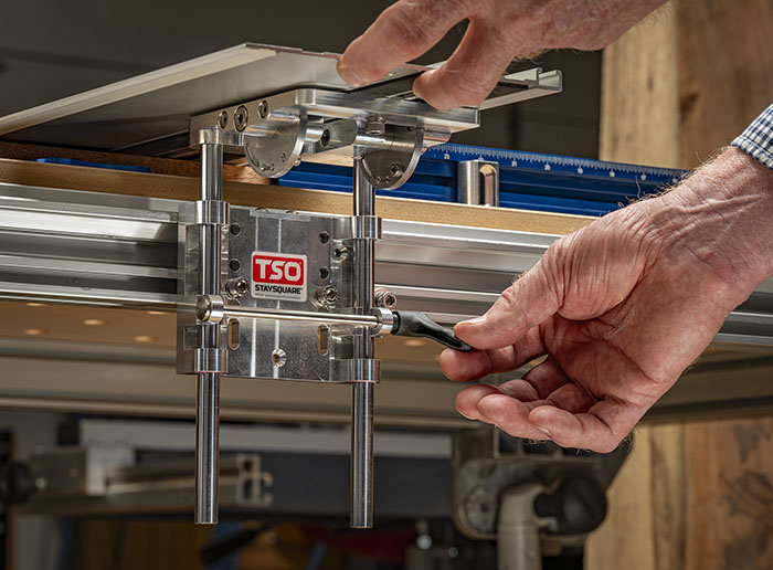 Hand gripping the lever on a StaySquare guide rail hinge
