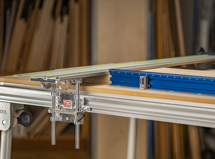 Removing a track saw guide rail and hinge assembly from an MFT-style table in one piece